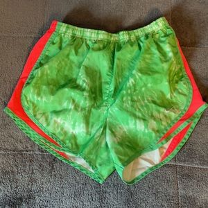 Green and pink Nike running shorts